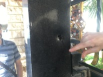 A bullet hole in the man's door.
